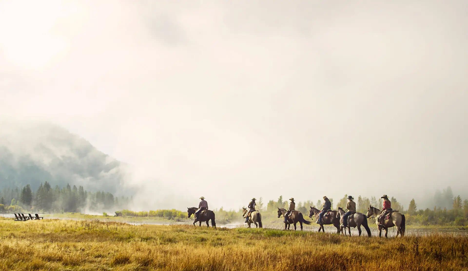 cowboys riding horses on a Noble House Hotels & Resorts property range