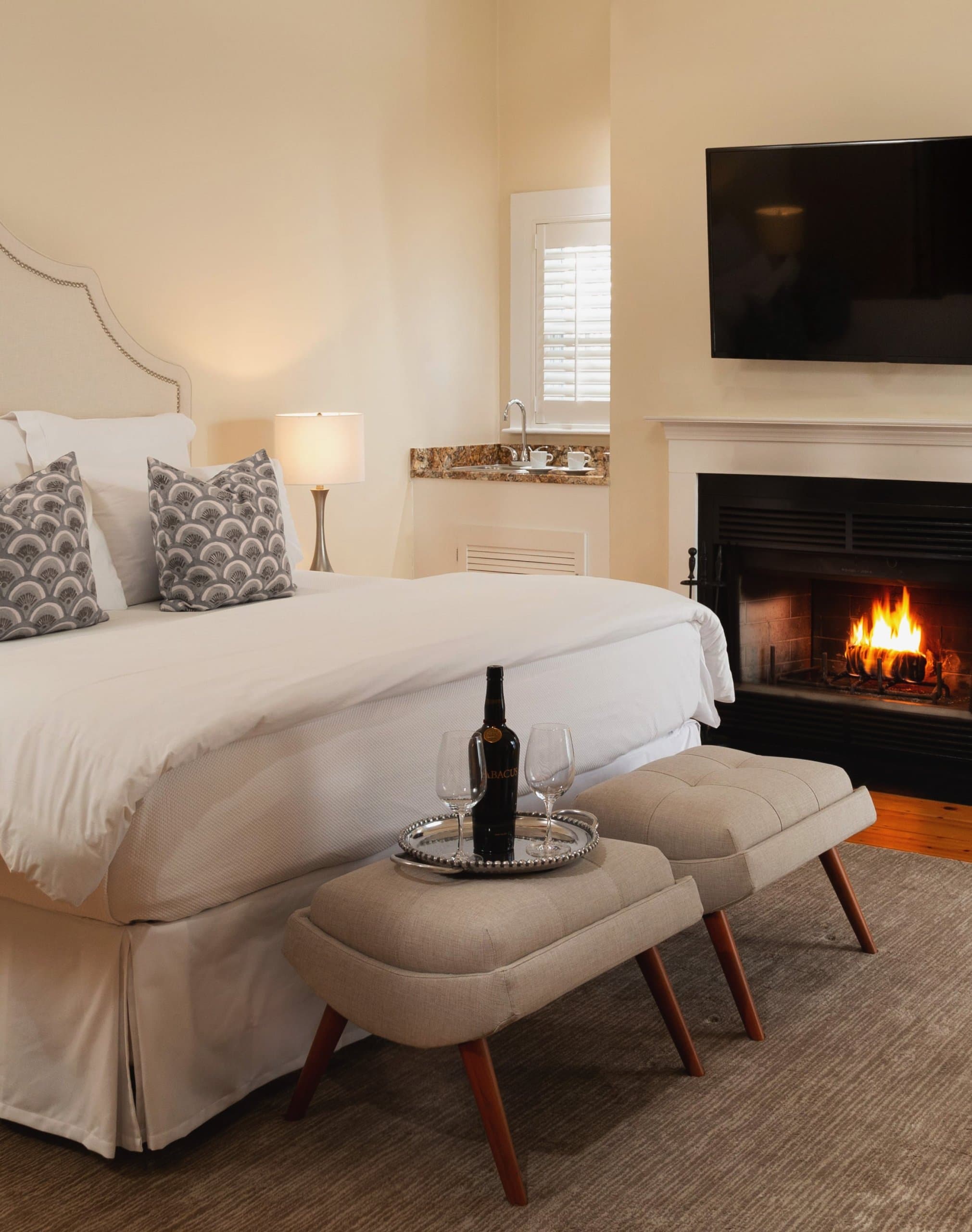 Hotel room with wine bottle and glasses on seats at the Chatham