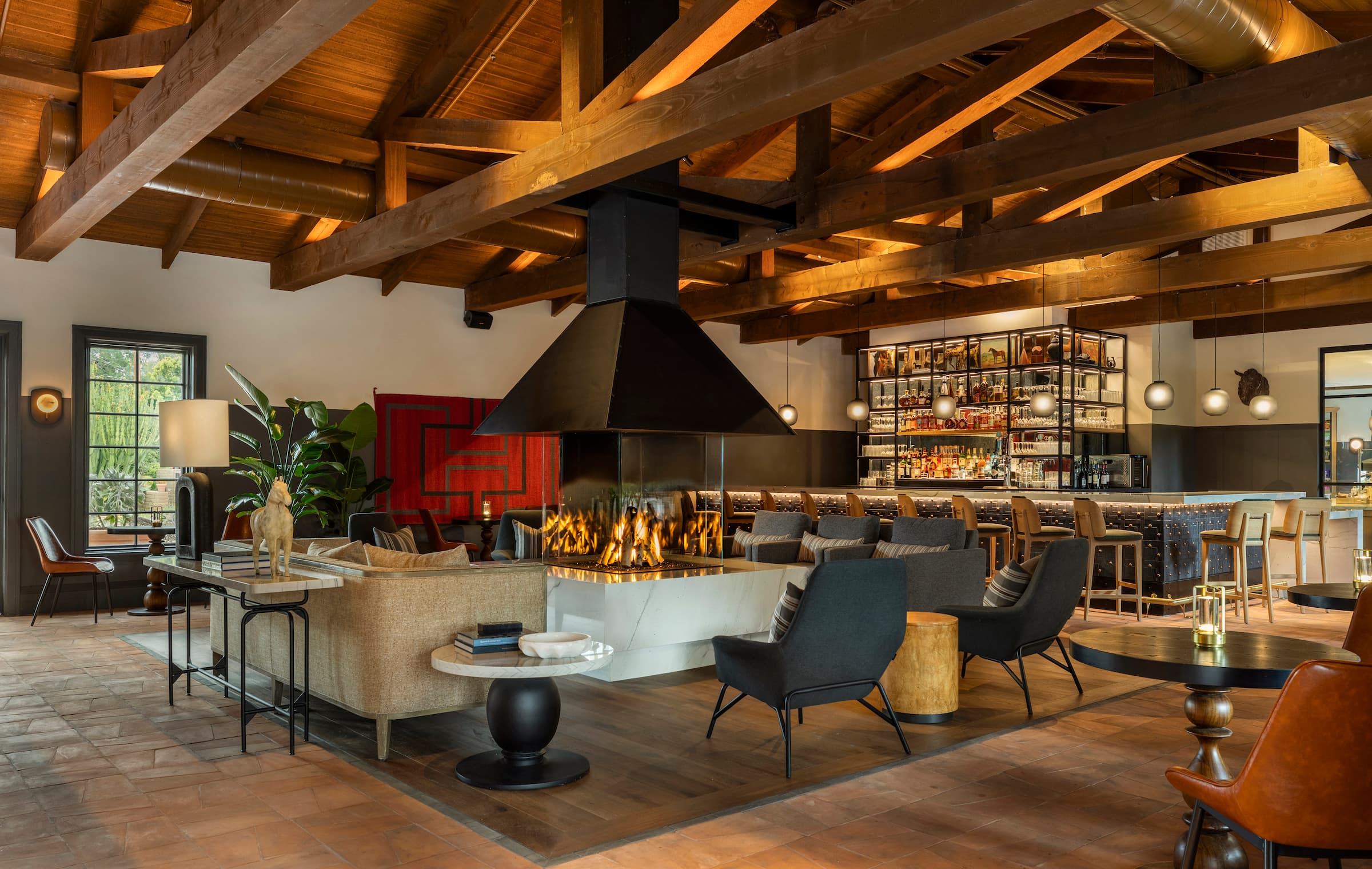 Seating area around indoor fireplace in Estancia La Jolla, California