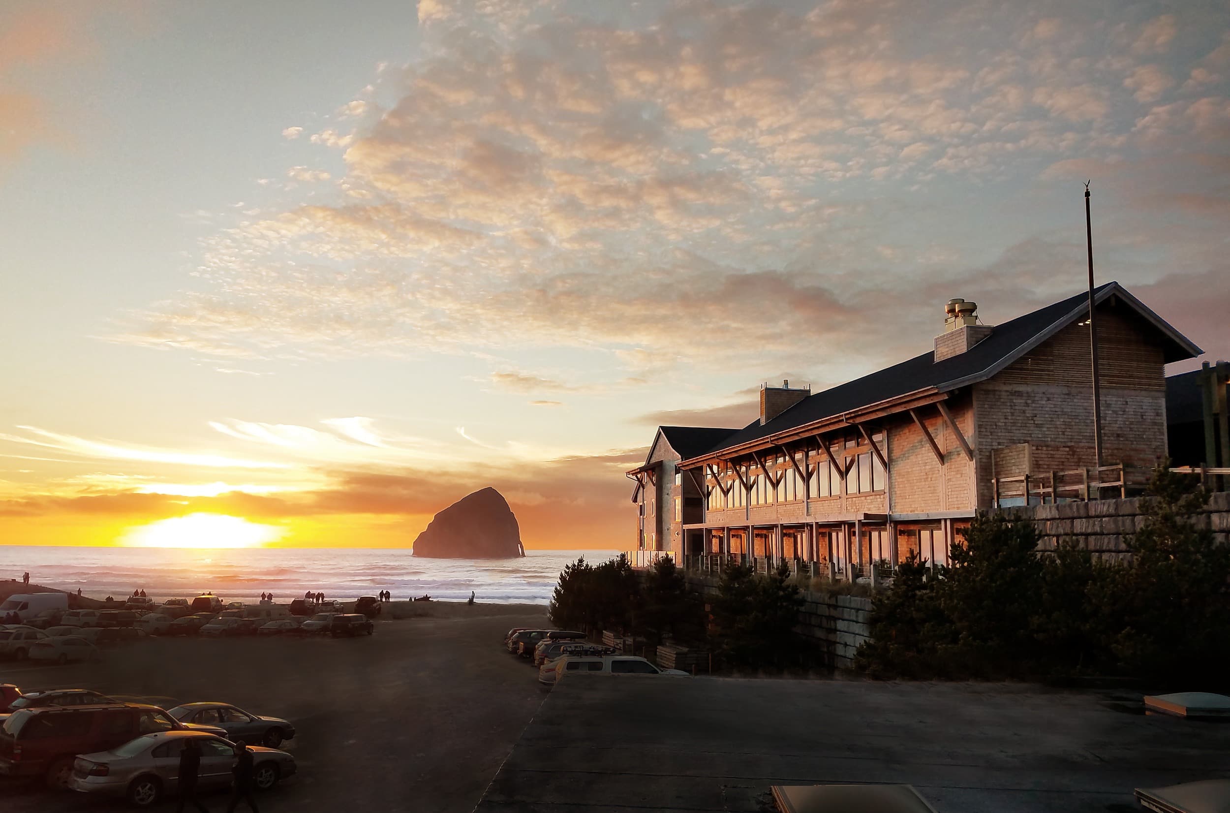 Oceanfront exterior of Headlands Coastal Lodge & Spa at golden hour above Pacific City beach, Oregon Coast