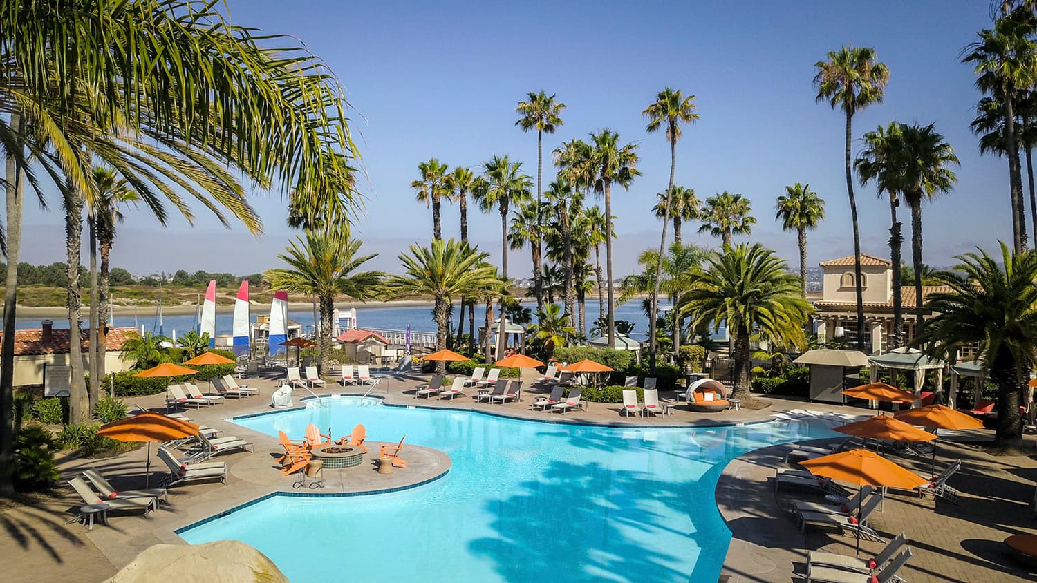 Pool with seating and shade at a Noble House Hotels & Resorts property