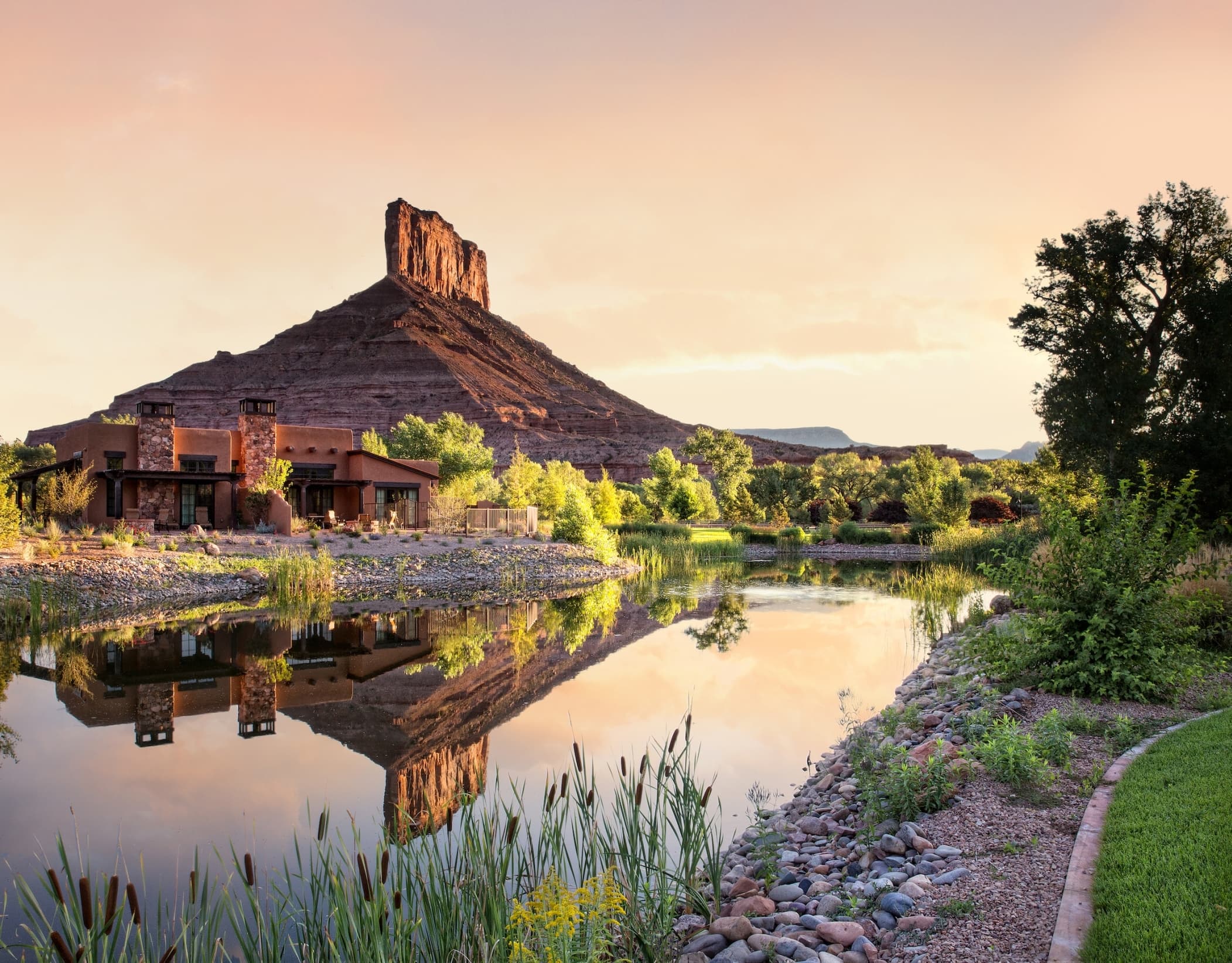 Gateway Canyons Resort & Spa building with water out front and mountain in the back in Gateway, Colorado