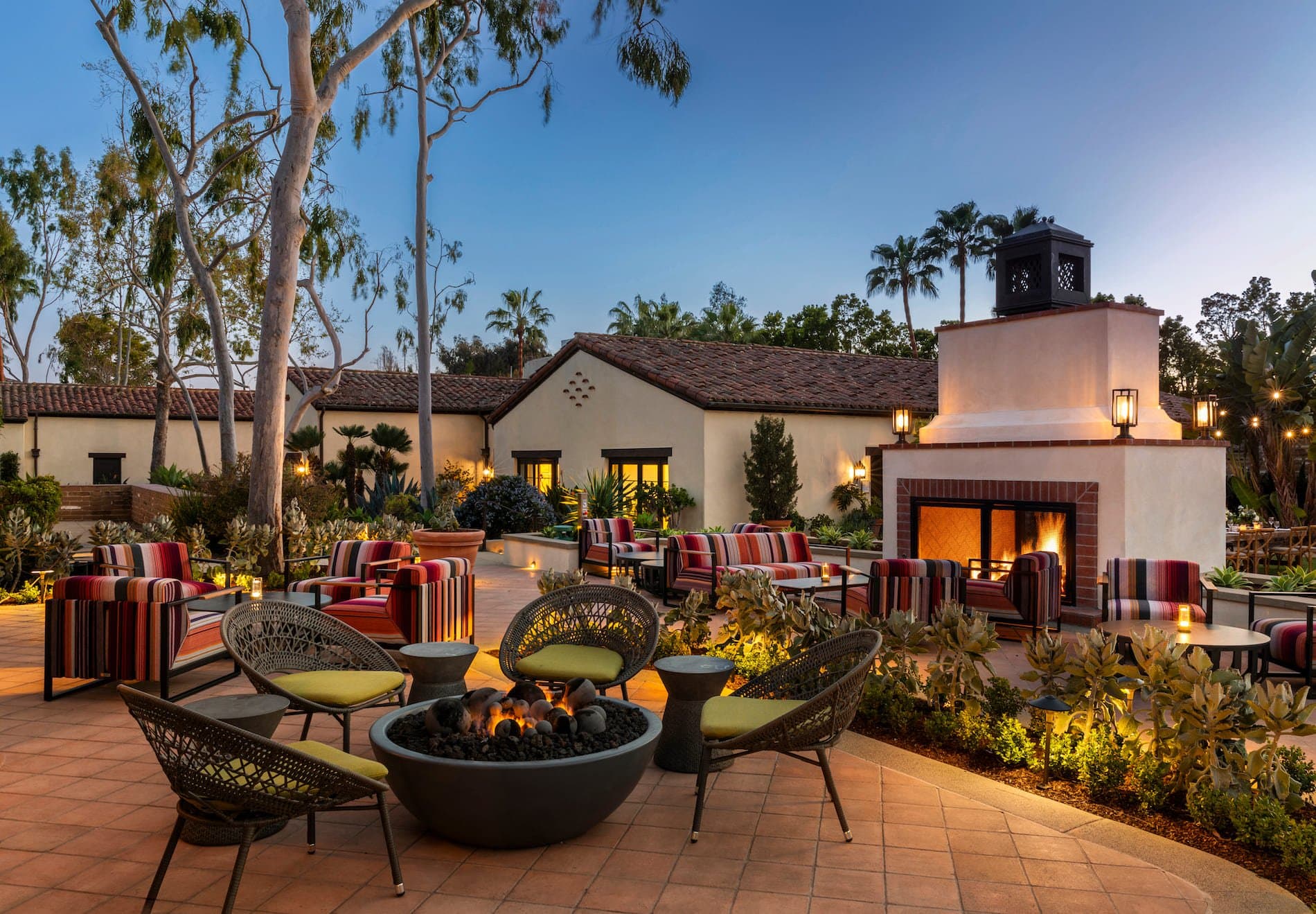 Back of a Noble House Hotels & Resorts property, with a seating area, a fire pit and a fireplace