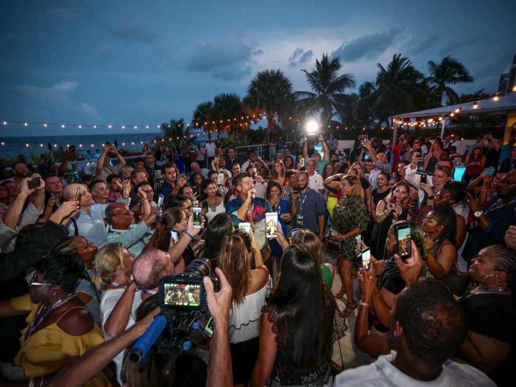 Party exterior with people taking selfies