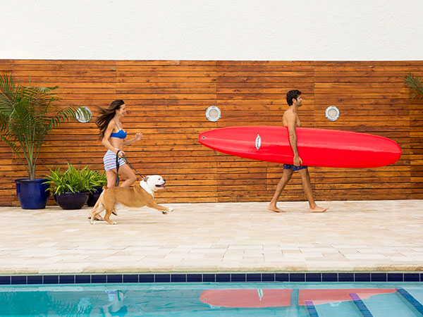 Couple With A Dog And Surf Board At Sole Miami.
