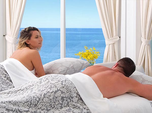Couple Getting A Massage At Pelican Grand Beach Resort.