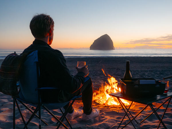 Guy On The Beach With A Campfire