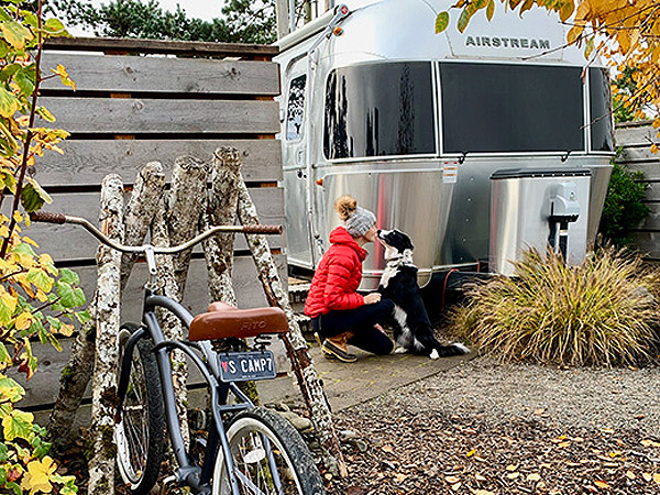 dog & mom in front of airstreem camper